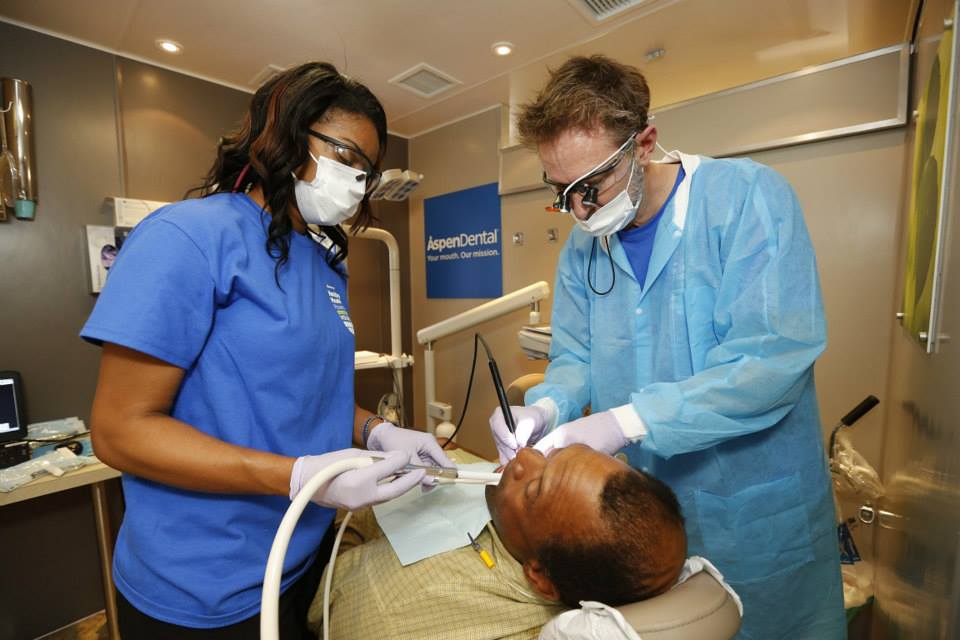 two dentists working on patient 