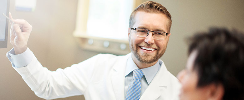 Dentist Providing Patient Education Smiling Aspen Dental