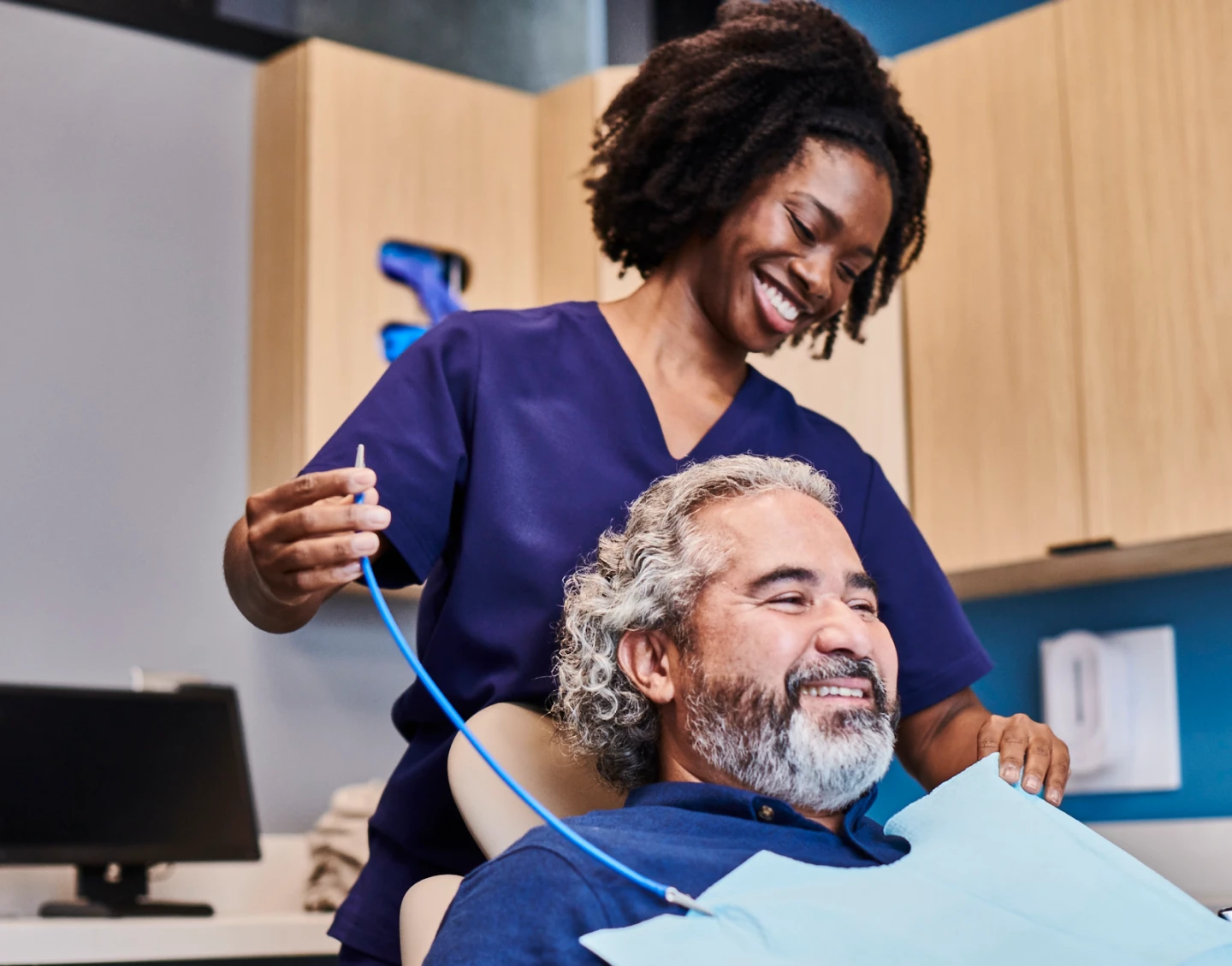 An Aspen Dental doctor prepares a patient for an exam. 