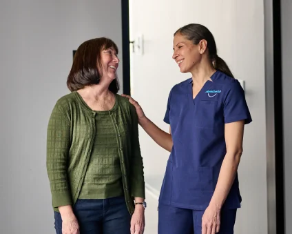 An Aspen Dental doctor laughs with a patient. 