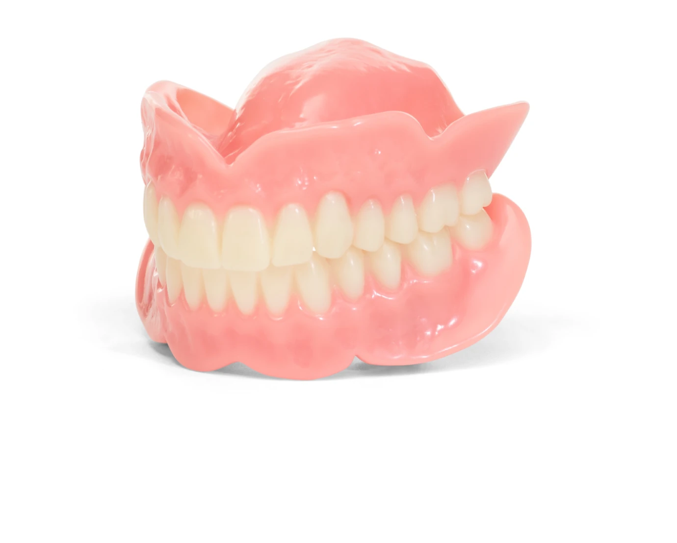A model of set of upper and lower full dentures made of pink acrylic and white resin teeth, displayed against a white background.
